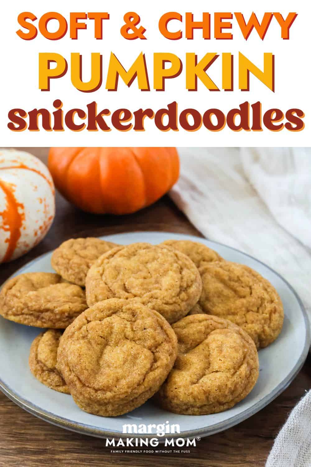 Easy pumpkin snickerdoodles on an ivory plate, with two mini pumpkins in the background.