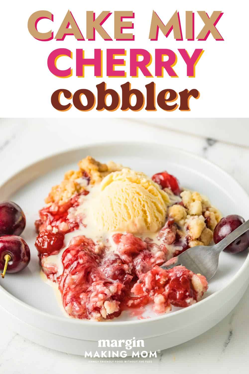 Cake mix cherry cobbler served on a white plate, topped with a scoop of vanilla ice cream.
