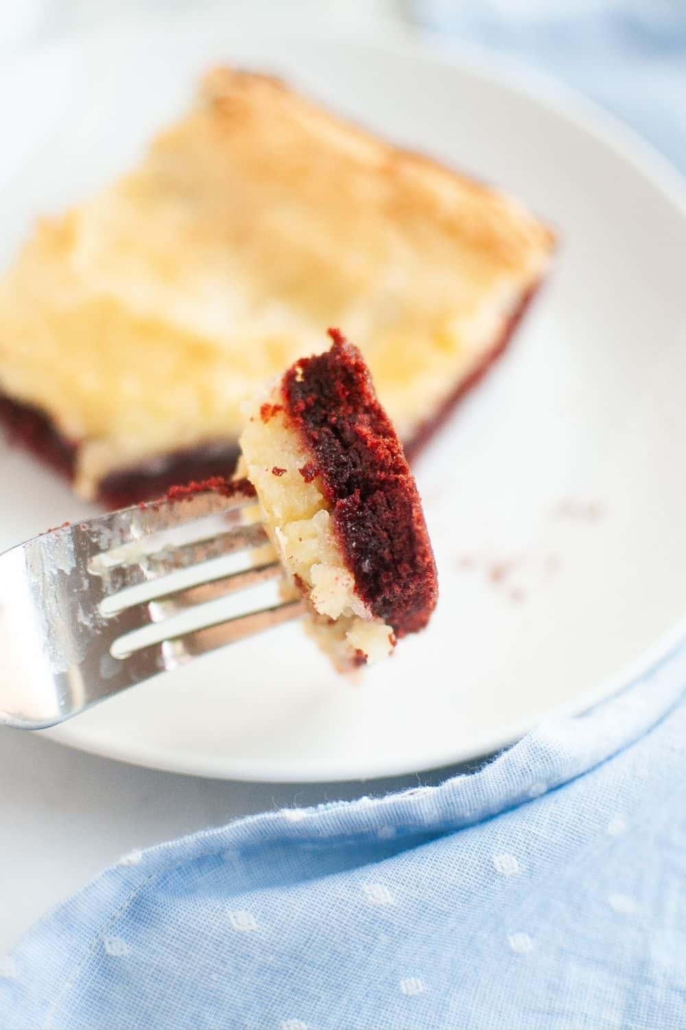 a fork holds a bite of southern red velvet chess square.
