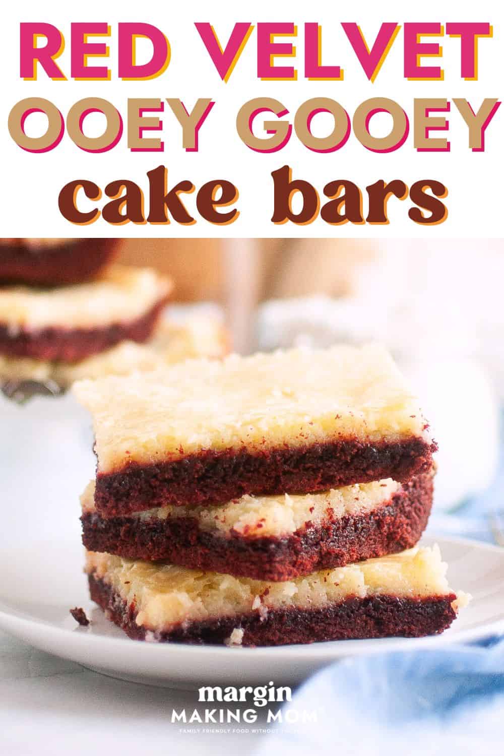 stack of red velvet ooey gooey bars on a white plate.