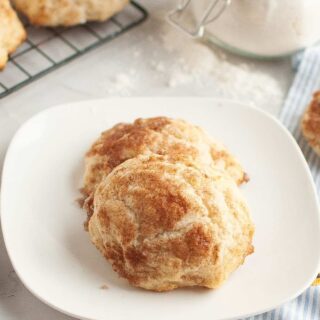 Two cinnamon sugar drop biscuits served on a white plate.