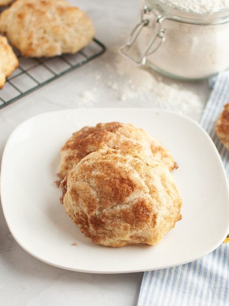 Two cinnamon sugar drop biscuits served on a white plate.