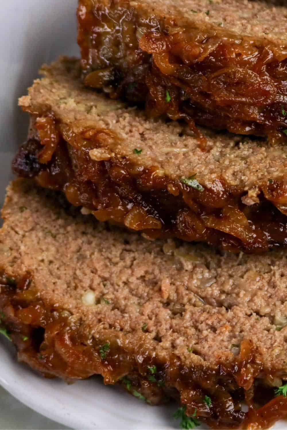 close-up view of slices of meatloaf made with Lipton onion soup mix, showcasing the moist interior and the caramelized onions on the tops of the slices.