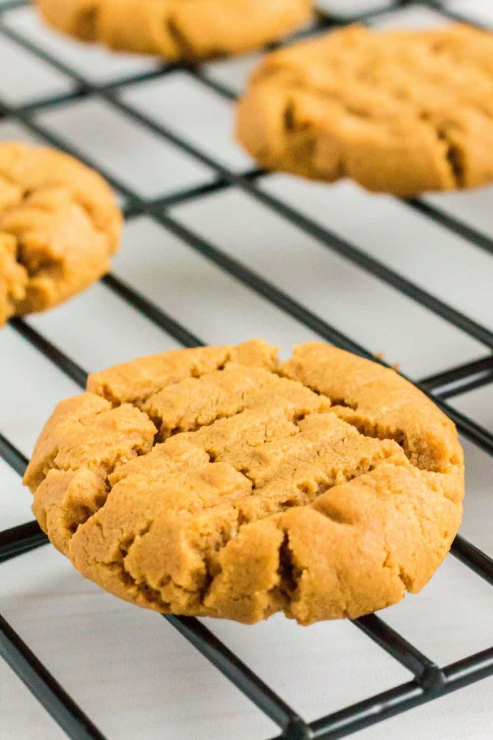 small batch peanut butter cookies on a wire rack.