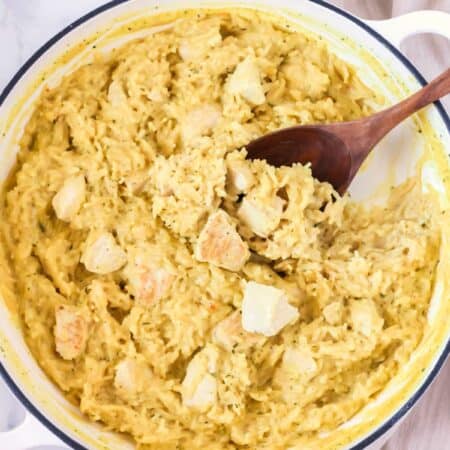 Knorr chicken and rice casserole in a pan with a wooden spoon.