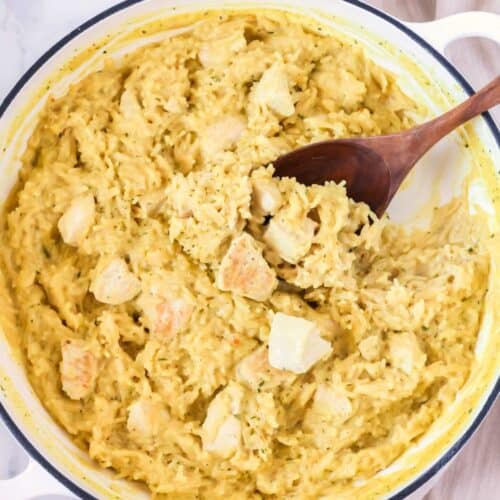 Knorr chicken and rice casserole in a pan with a wooden spoon.