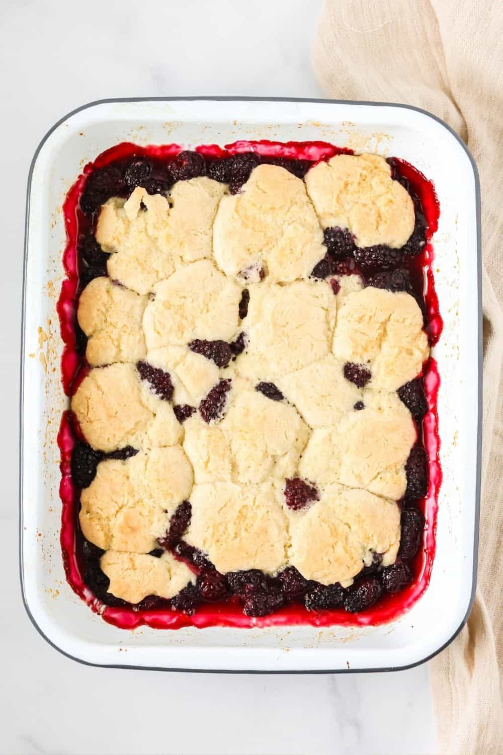 overhead view of a pan of freshly baked Bisquick blackberry biscuit cobbler.
