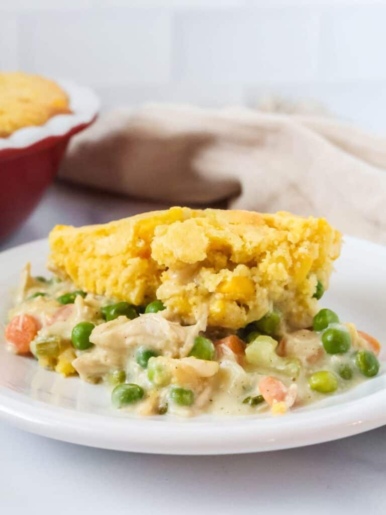 Cornbread chicken pot pie served on a white plate.