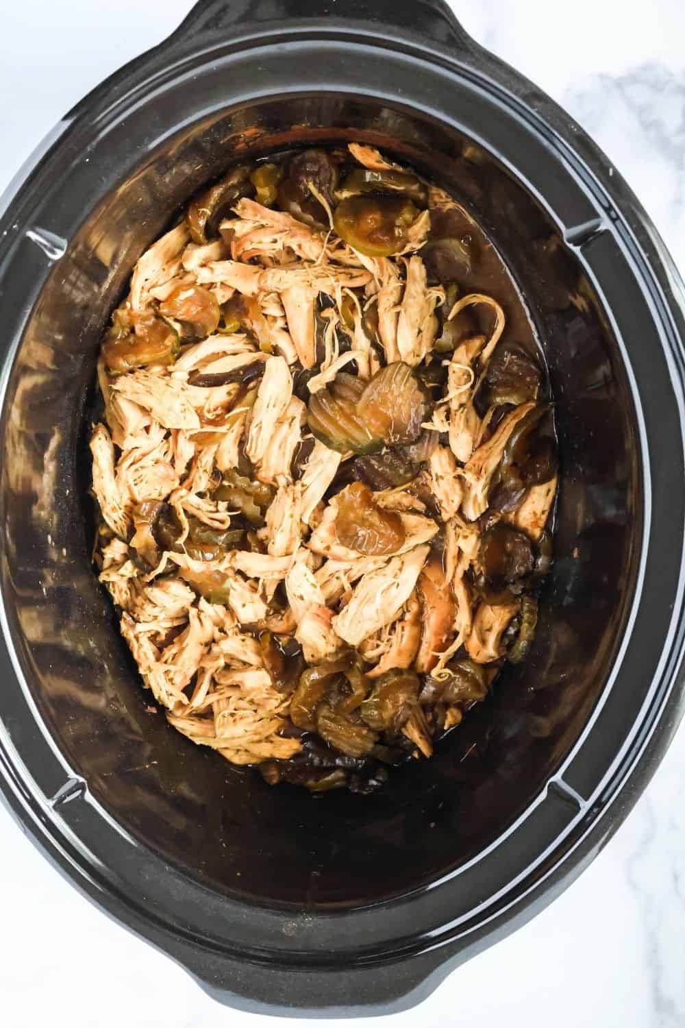 overhead view of a slow cooker liner filled with dill pickle chicken.