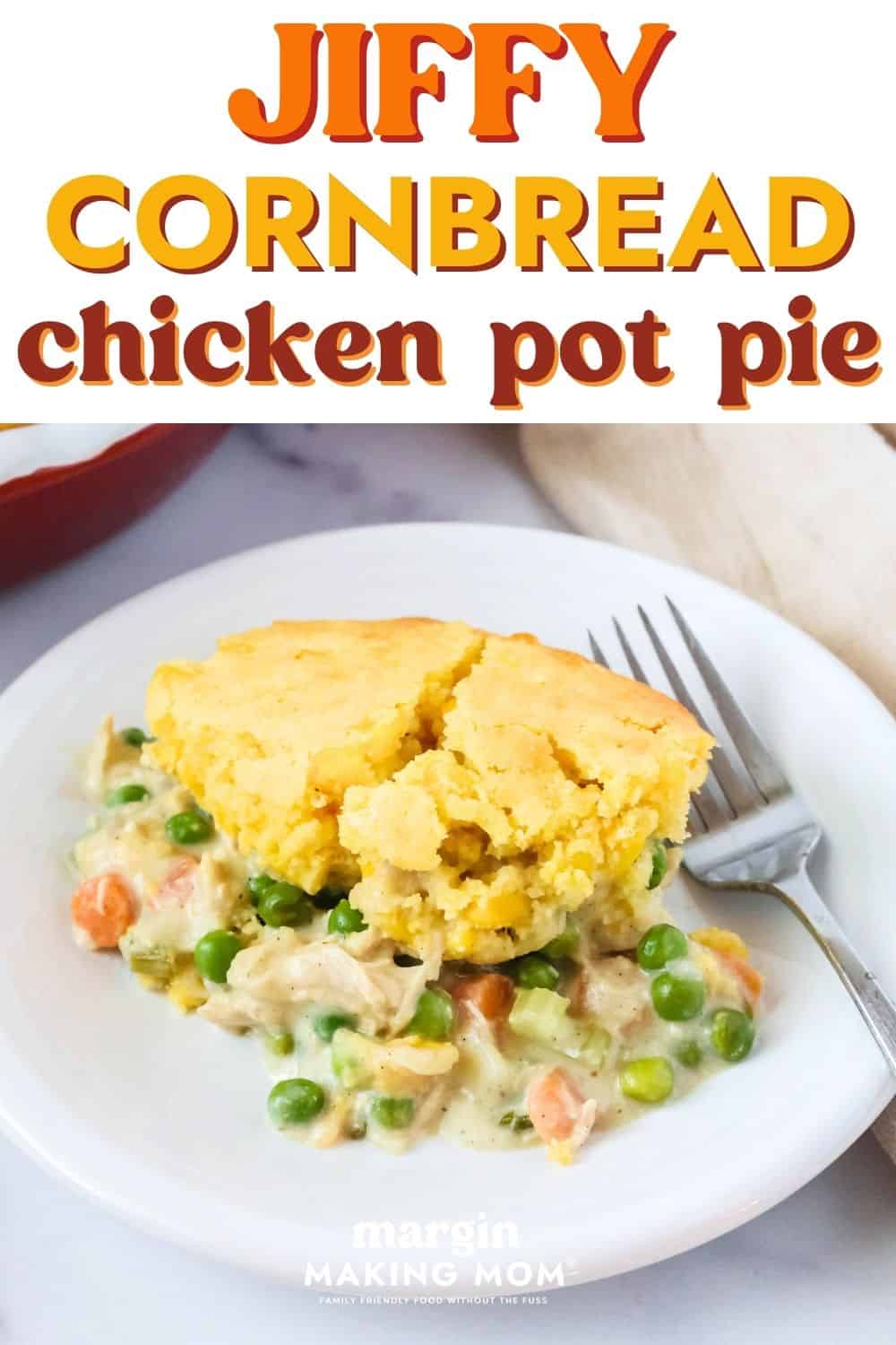 cornbread chicken pot pie served on a white plate with a fork next to it.