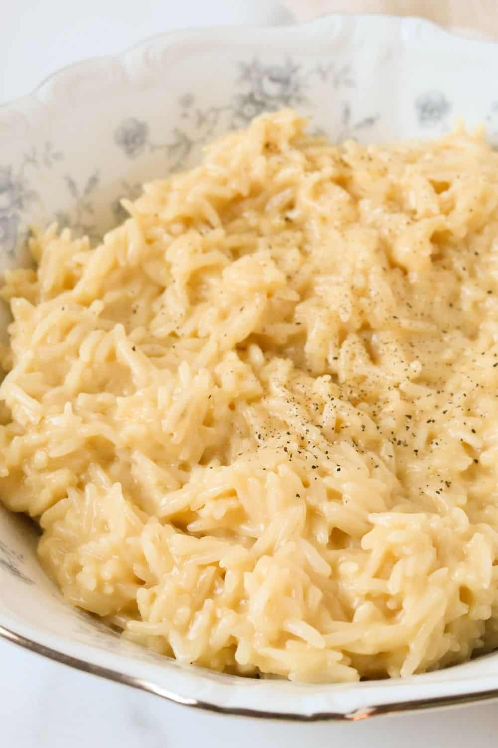 close-up view of cheater risotto in a blue and white serving bowl.