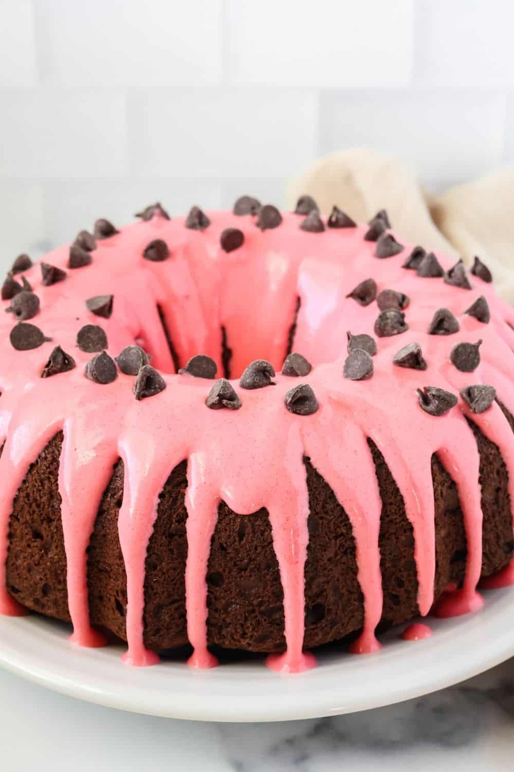 chocolate strawberry glazed cake topped with chooclate chips.