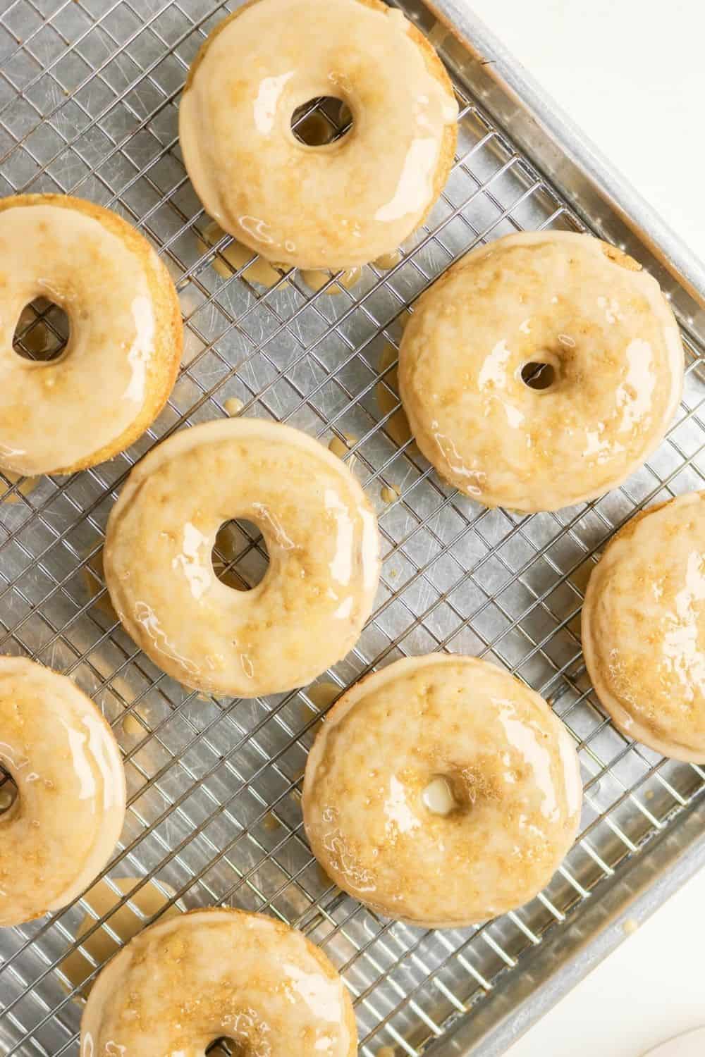 overhead view of coffee glazed donuts baked in a donut pan and placed on a wire rack so the icing can set.