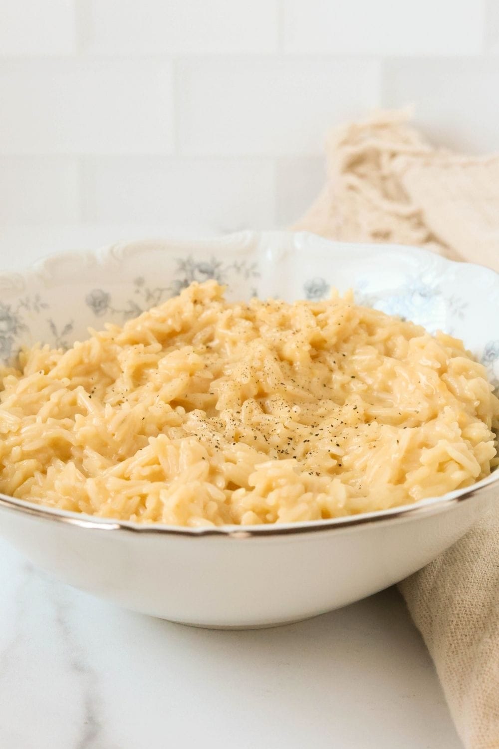 side view of souper rice made with regular rice instead of instant rice, served in a white and blue bowl.