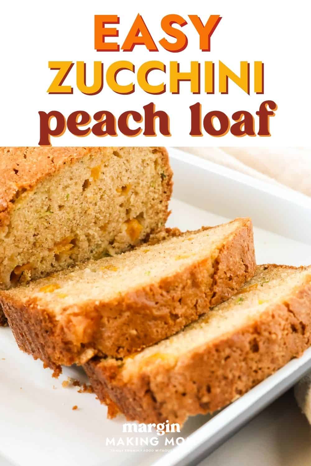A sliced loaf of peach zucchini bread on a white serving plate.