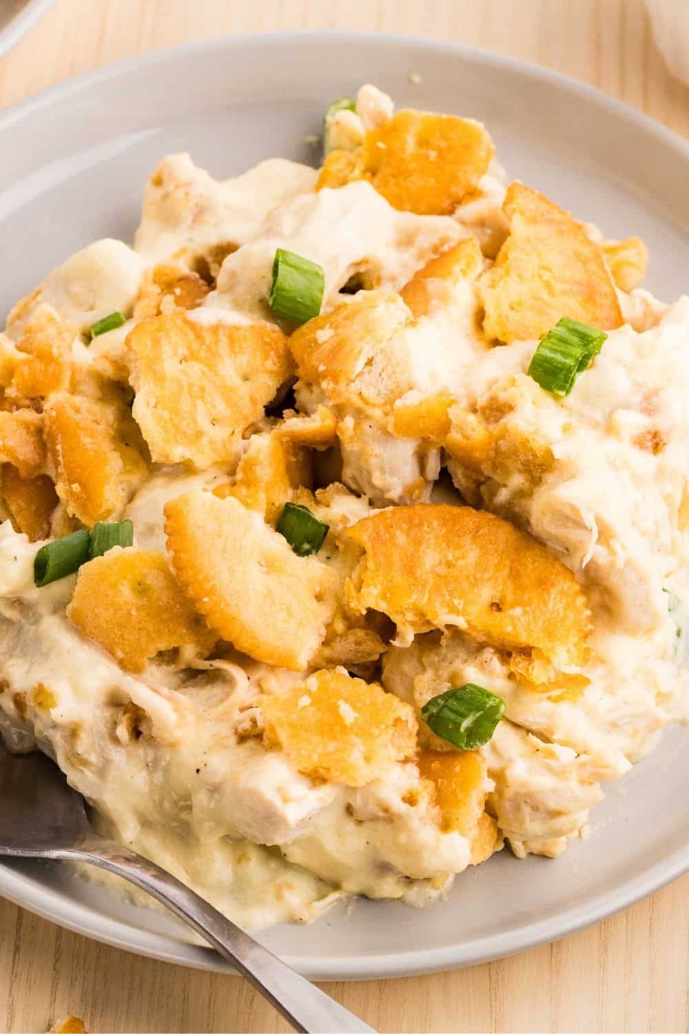 A serving of Ritz chicken casserole made with rotisserie chicken, served on a plate, showcasing the creamy filling and crispy Ritz cracker topping.
