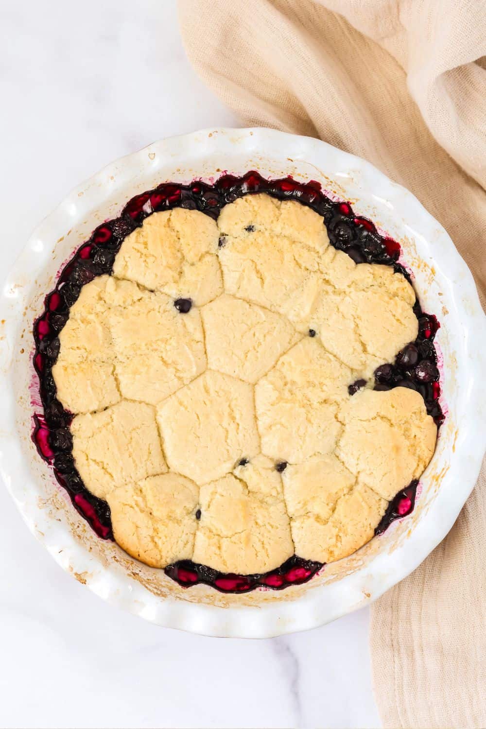 overhead view of southern blueberry sonker cobbler in a white pie plate.