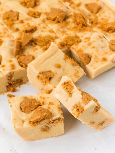 Biscoff fudge cut into squares on a piece of parchment.