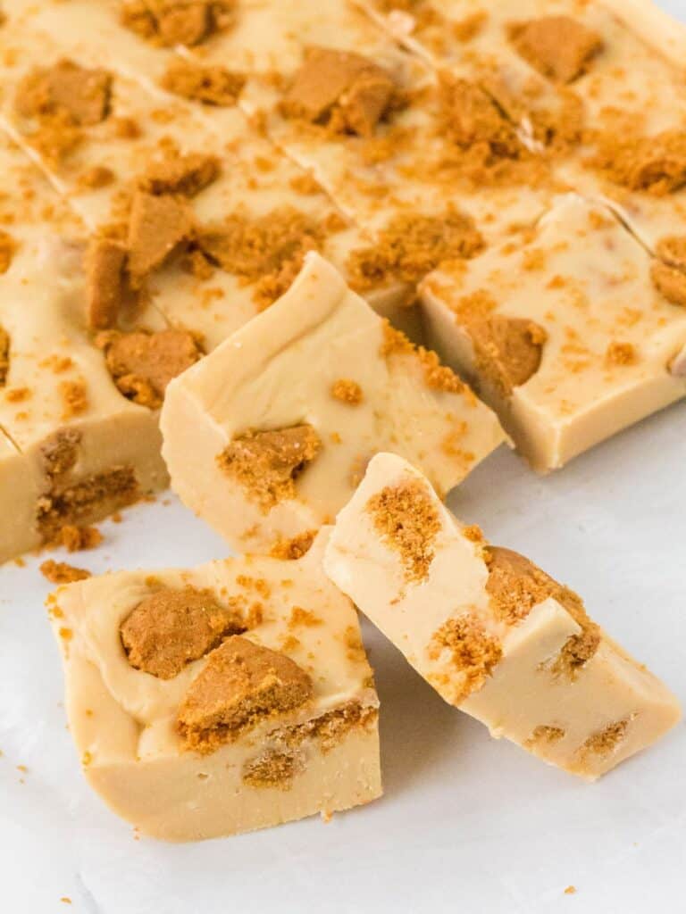 Biscoff fudge cut into squares on a piece of parchment.