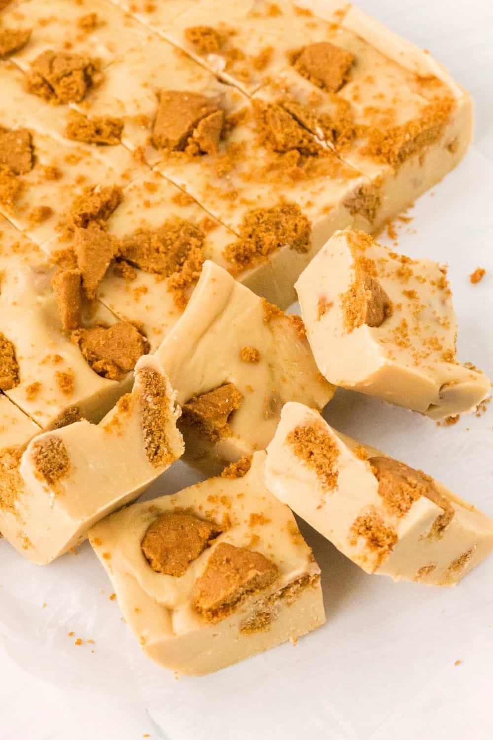 Pieces of easy Biscoff fudge cut from the slab of fudge.