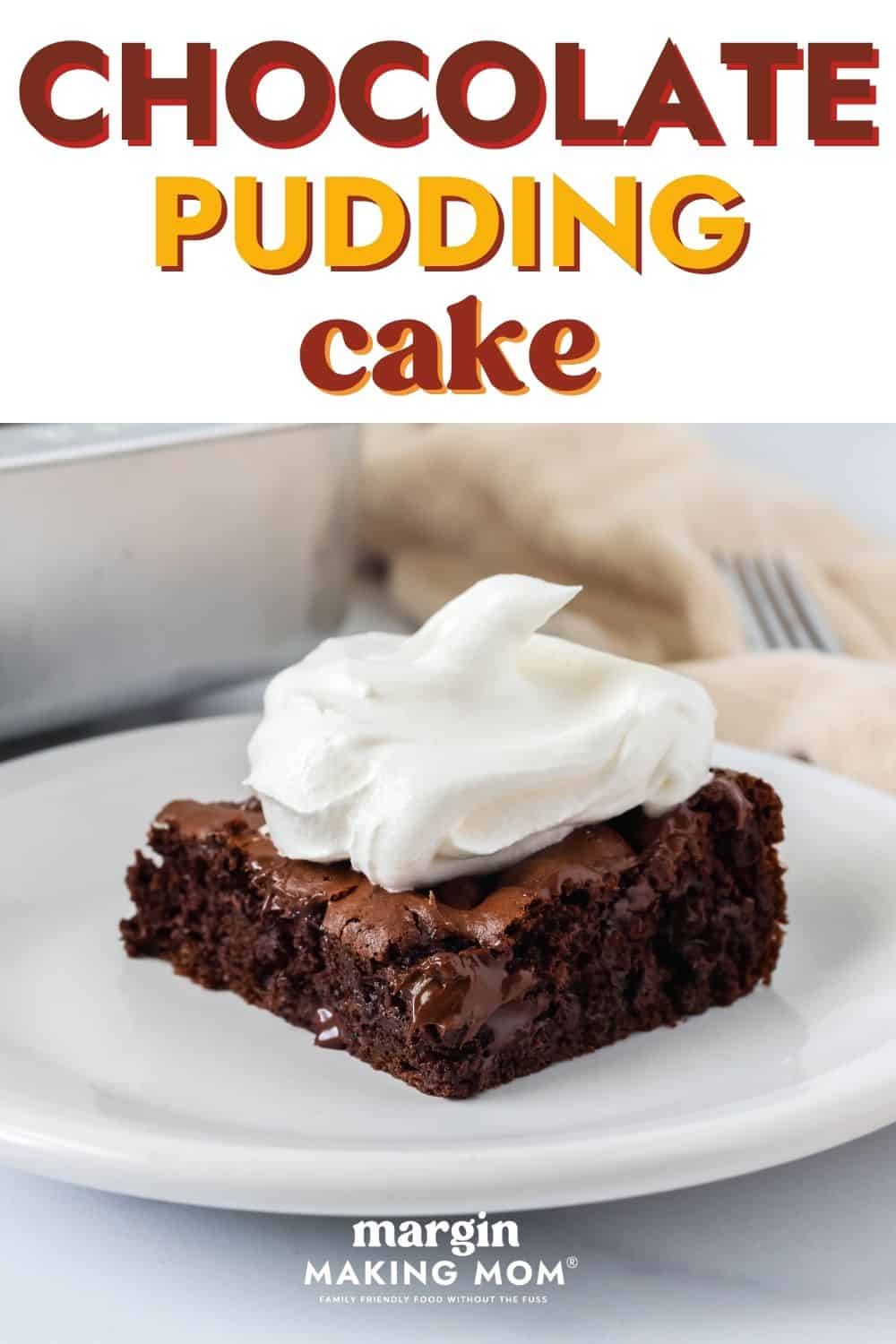 Easy chocolate pudding dump cake slice on a white plate, topped with Cool Whip.