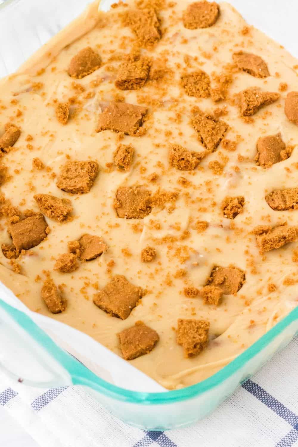 A glass pan filled with speculoos fudge that hasn't been cut yet.