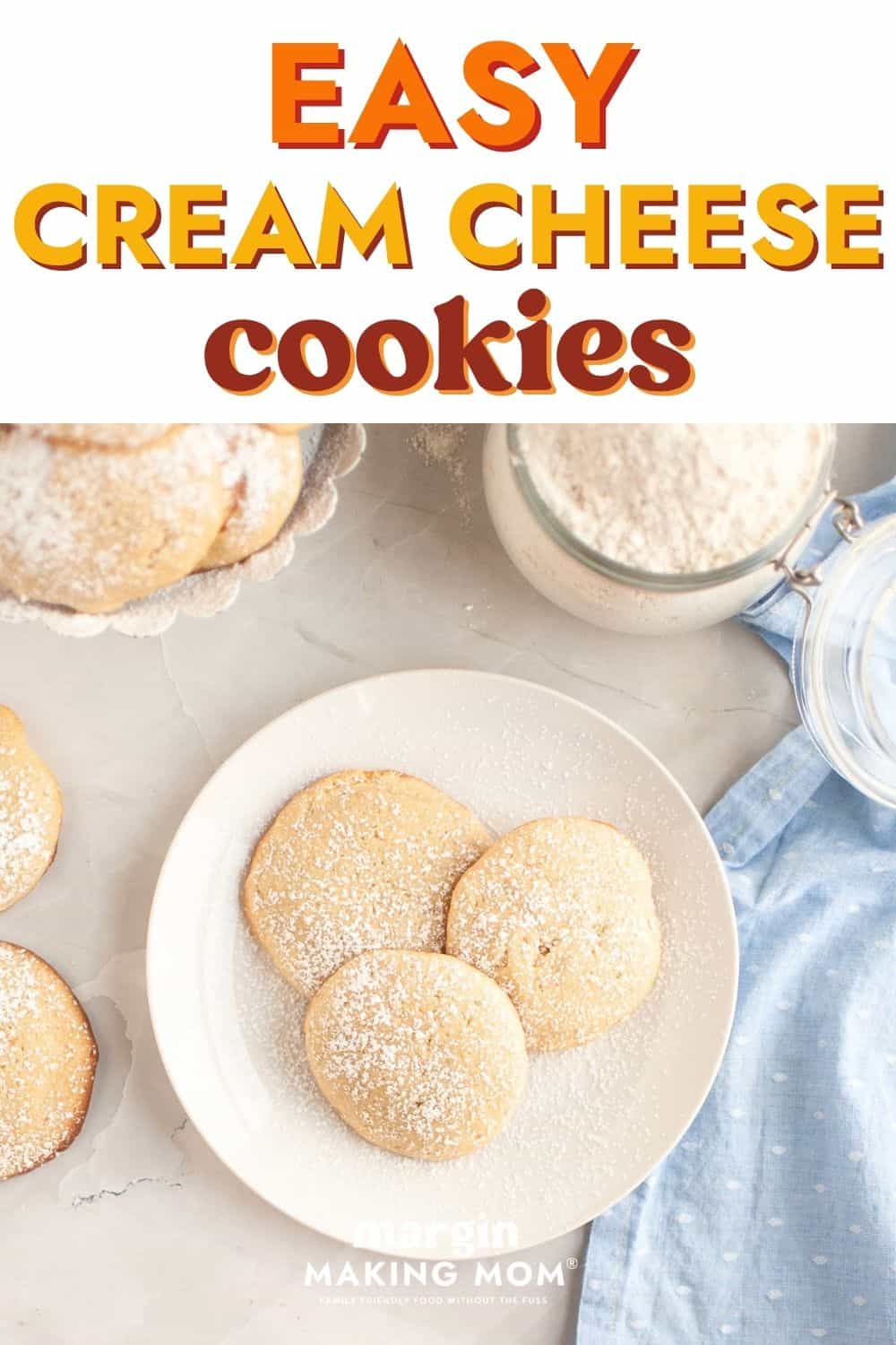 Overhead view of a few easy cream cheese cookies served on a white plate, dusted with powdered sugar.
