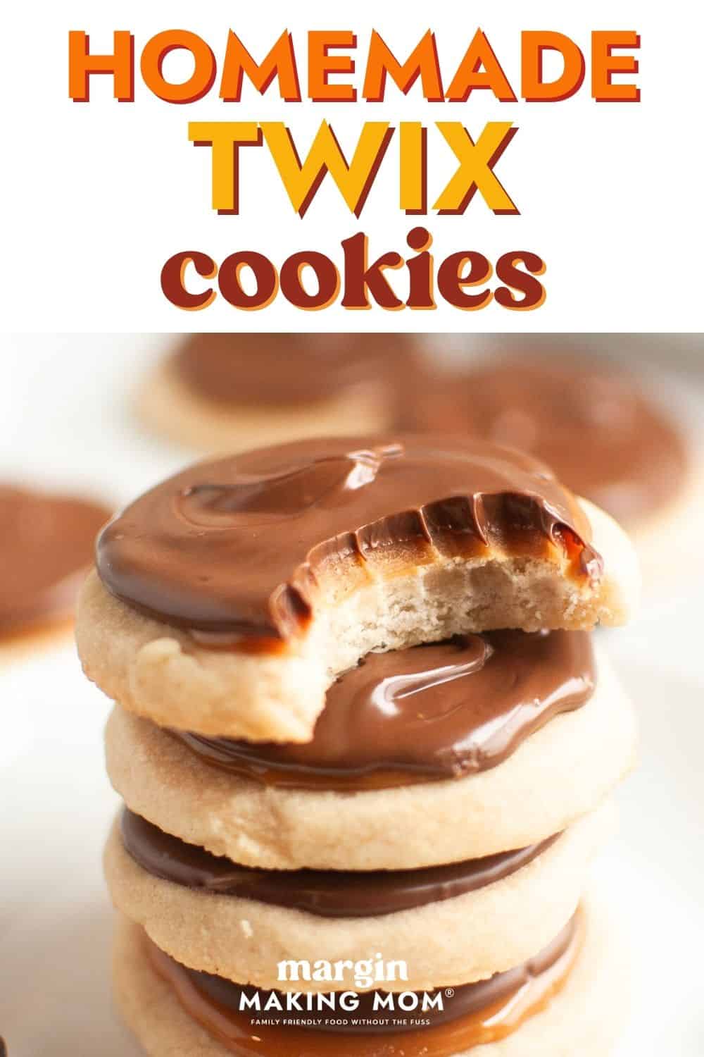 Stack of four Twix cookies. The top cookie has a bite taken out of it, showcasing the layers of shortbread, caramel, and chocolate.