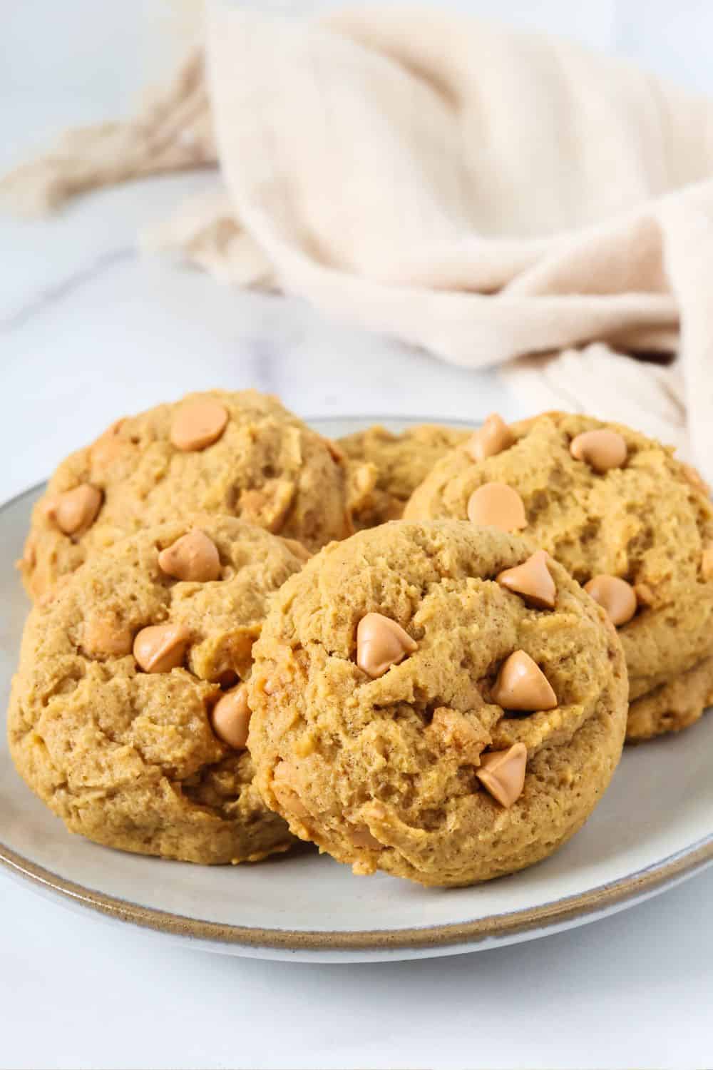 Homemade, soft pumpkin butterscotch cookies served on a small ivory plate.