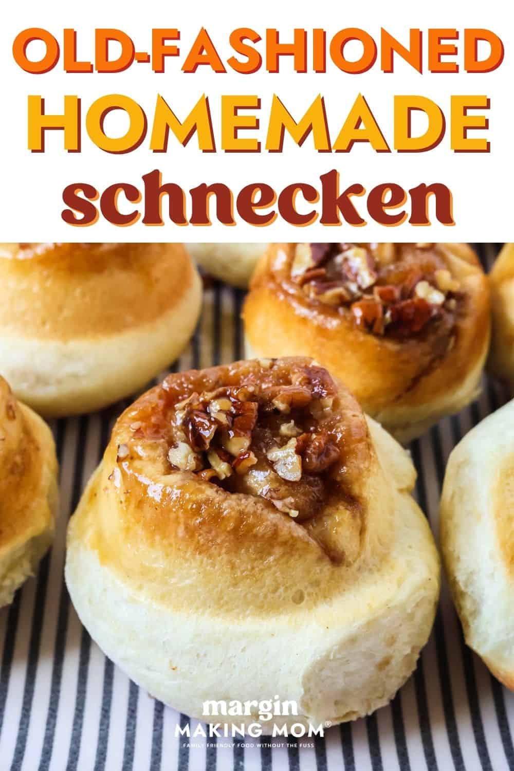 Close-up view of homemade schnecken sweet rolls on a blue and white striped platter.