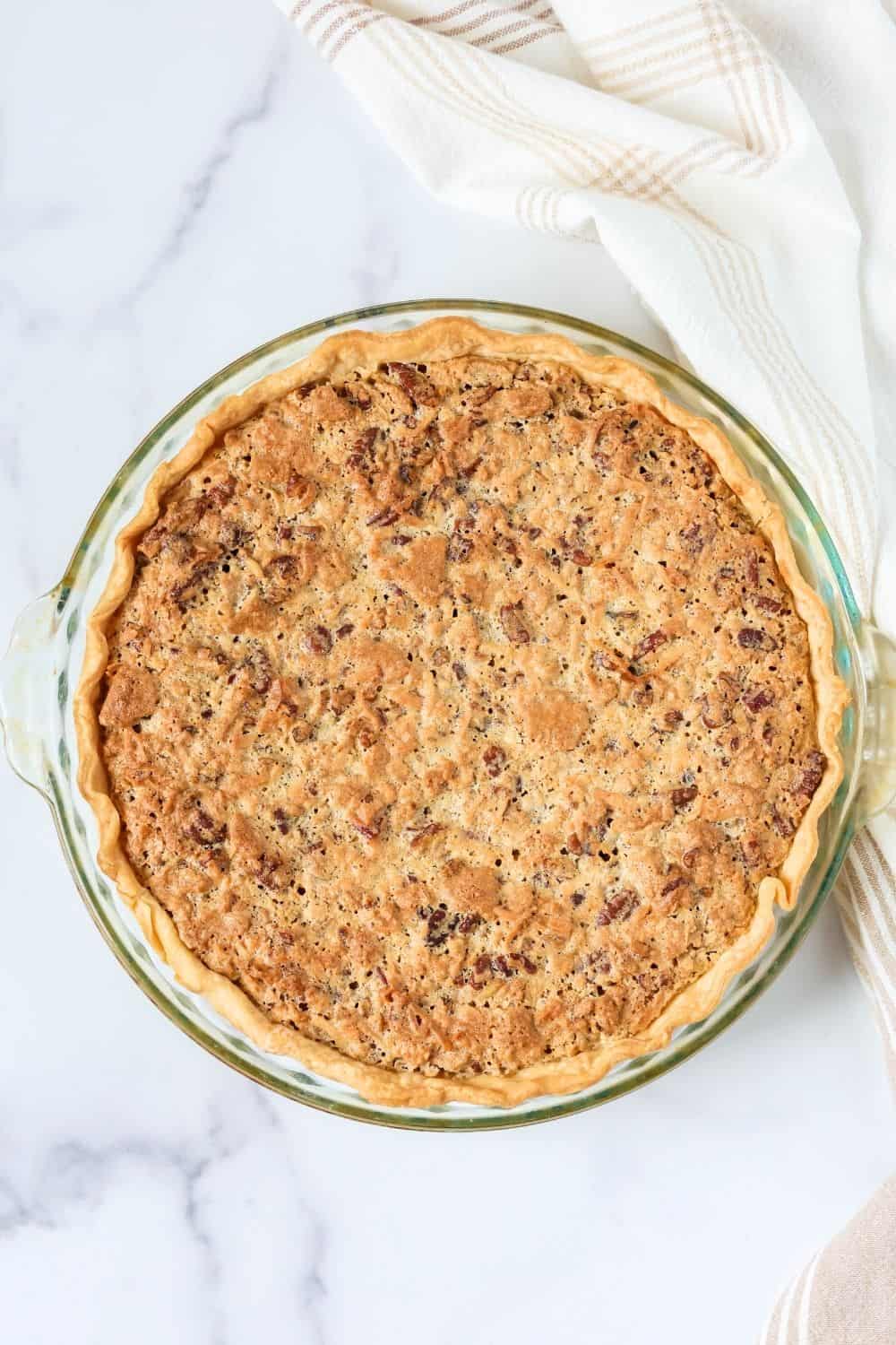 Overhead view of a whole sawdust pie in a glass pie pan.