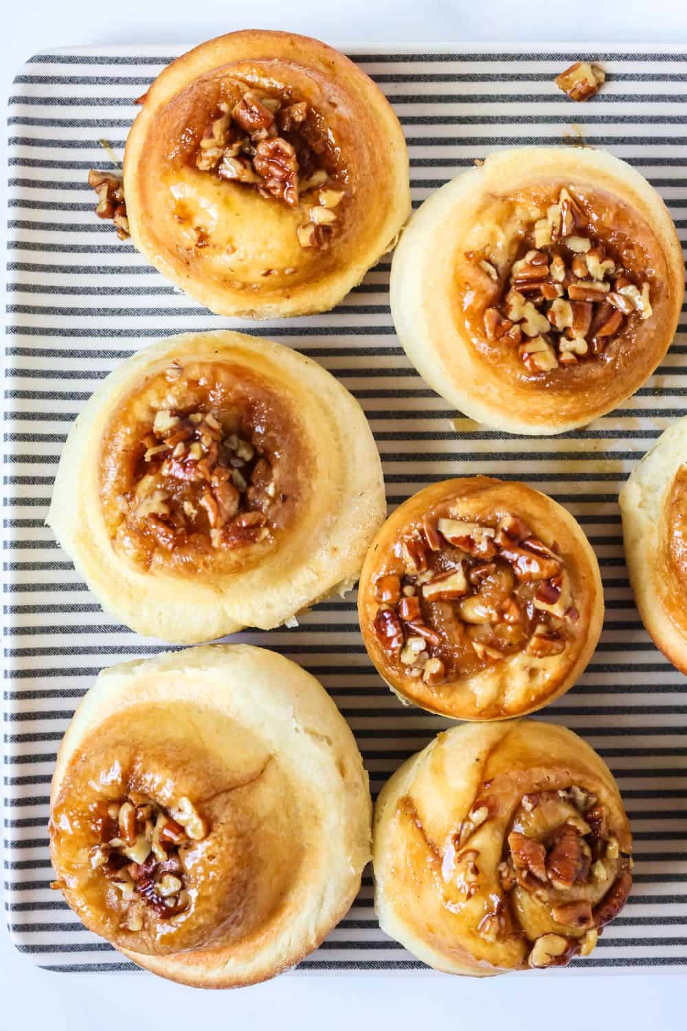 Overhead view of schnecken rolls covered with pecans and caramelized brown sugar.