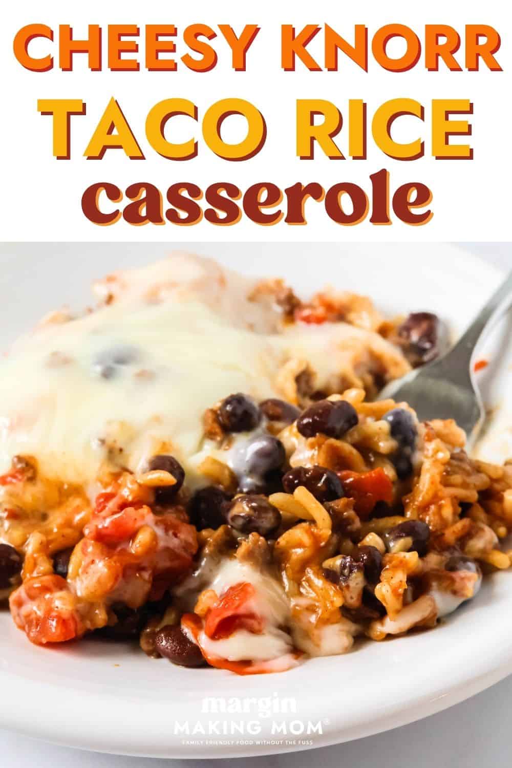A serving of cheesy Knorr taco rice casserole on a white plate, with a fork on the plate.