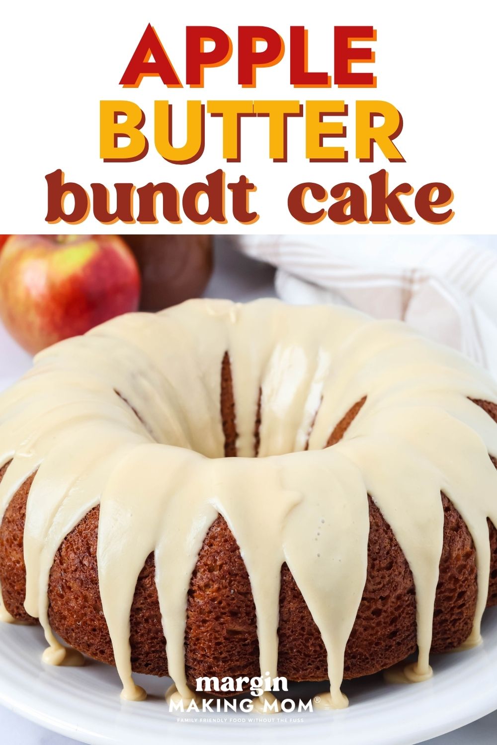 Apple butter bundt cake topped with brown sugar icing drizzle. A fresh apple and jar of apple butter are in the background.