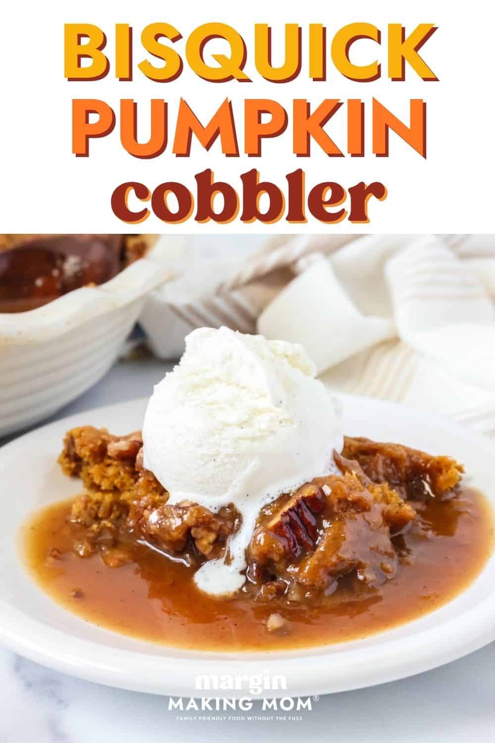 Bisquick pumpkin cobbler topped with vanilla ice cream and served on a white plate.