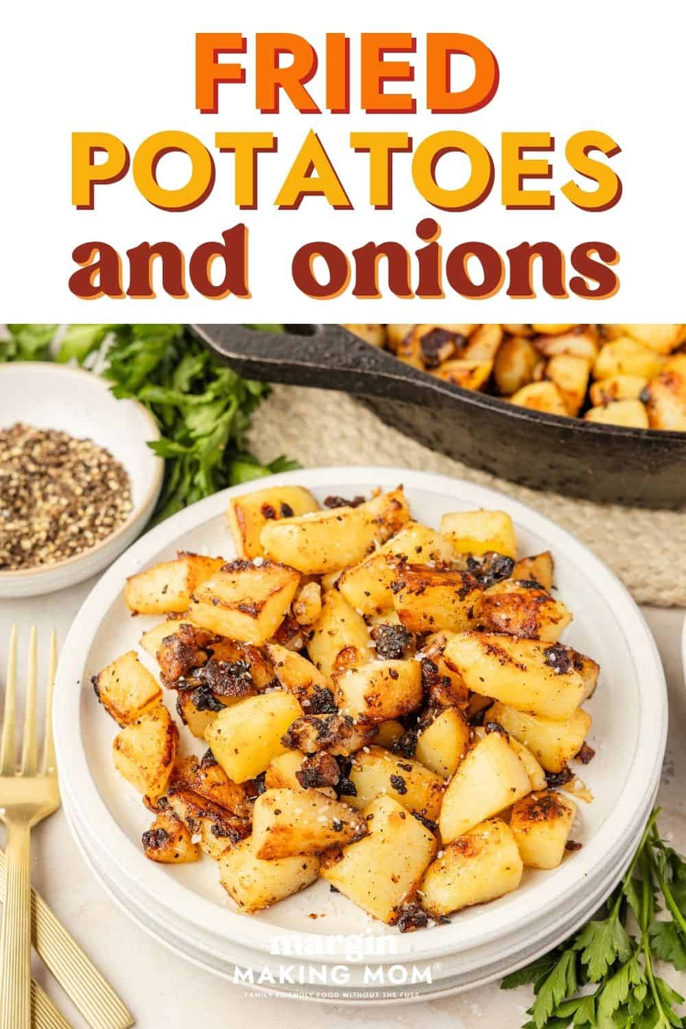 Fried potatoes and onions served on a white plate, with a skillet of more potatoes in the background.