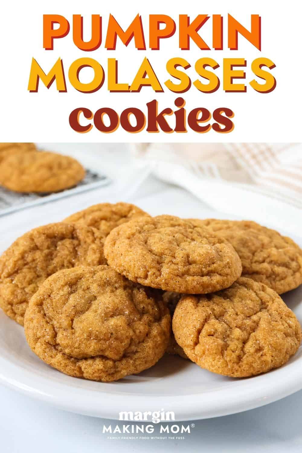 Side view of pumpkin molasses cookies served on a white plate.