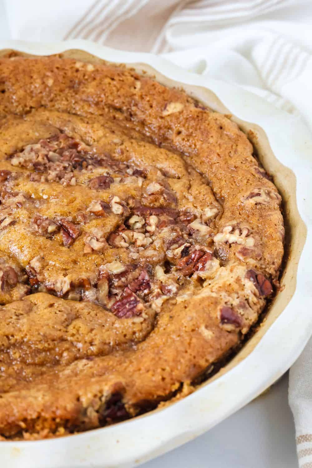 Close-up view of a freshly baked pumpkin pecan cobbler made with Bisquick, showcasing the cake layer on top.
