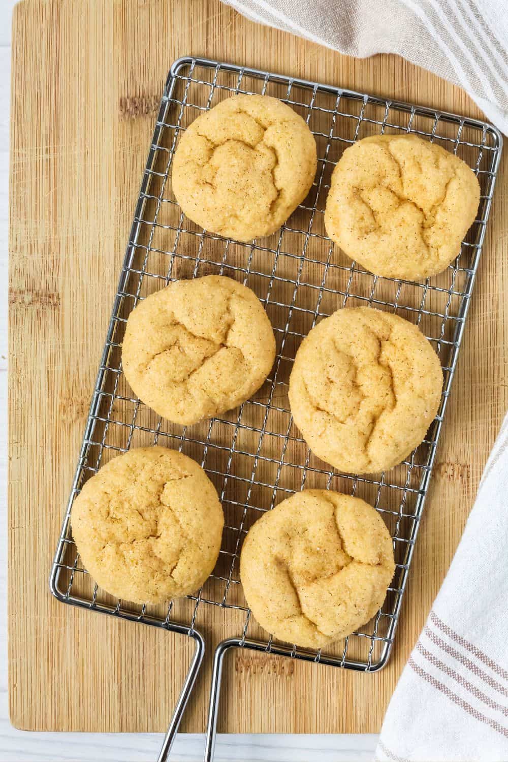 Soft pumpkin sugar cookies on a wire cooling rack.