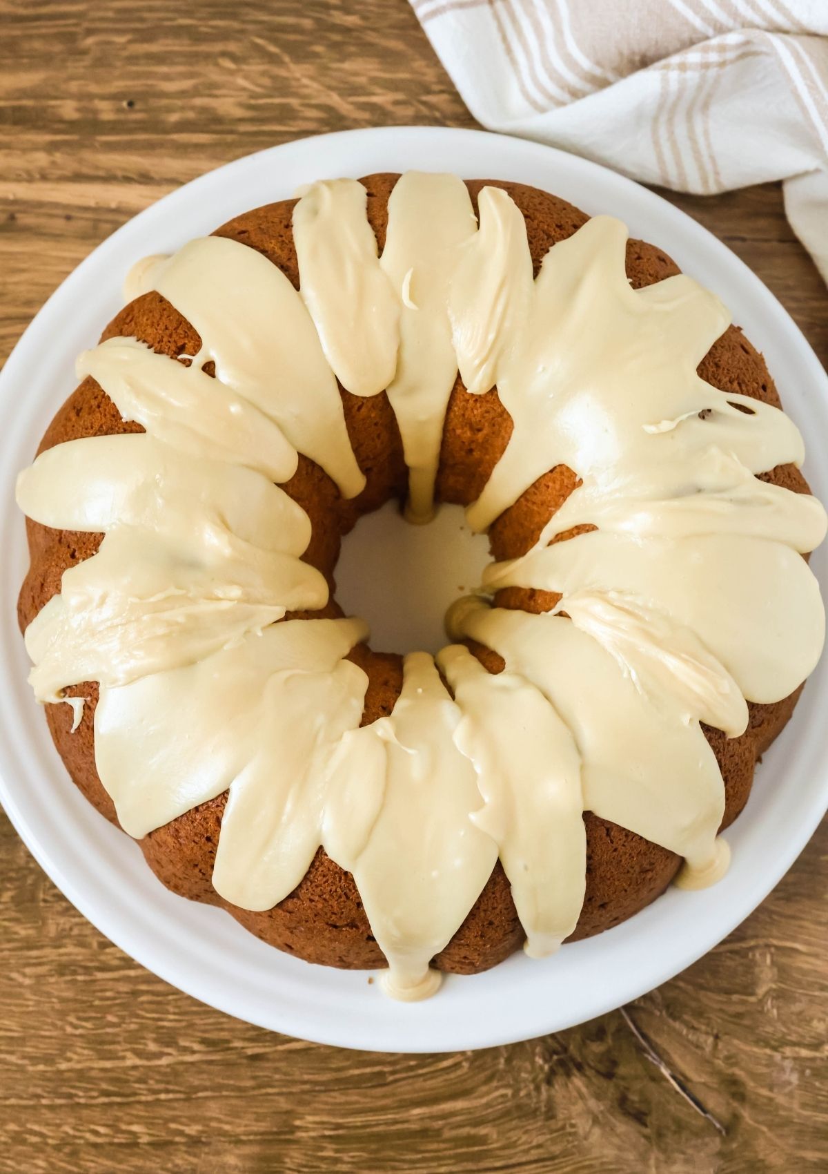 Overhead view of a brown sugar pound cake made with cake mix, topped with brown sugar icing and served on a white plate.