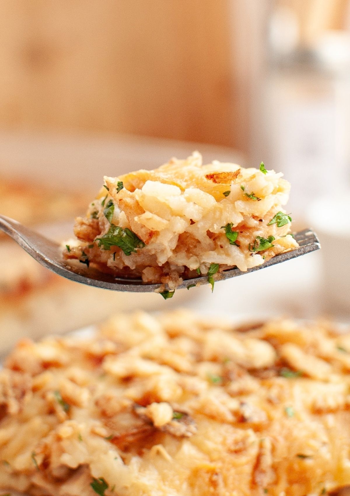 A fork scoops out a bite of chicken and rice made with french onion soup mix.