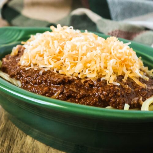 Cincinnati chili (copycat Skyline chili) served over spaghetti and topped with shredded cheese.