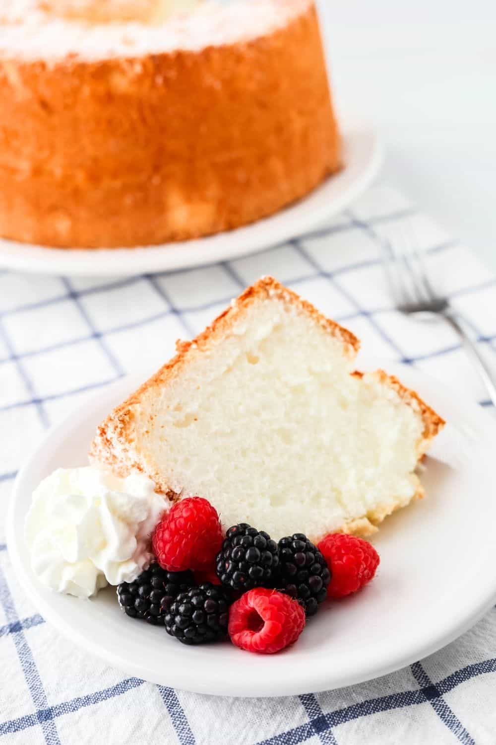 fat-free angel food cake served on a white plate with fresh berries and reduced fat Cool Whip.