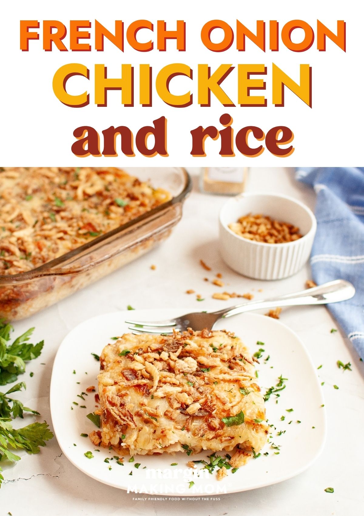 A serving of french onion chicken and rice on a white plate with a fork. The casserole dish is in the background.