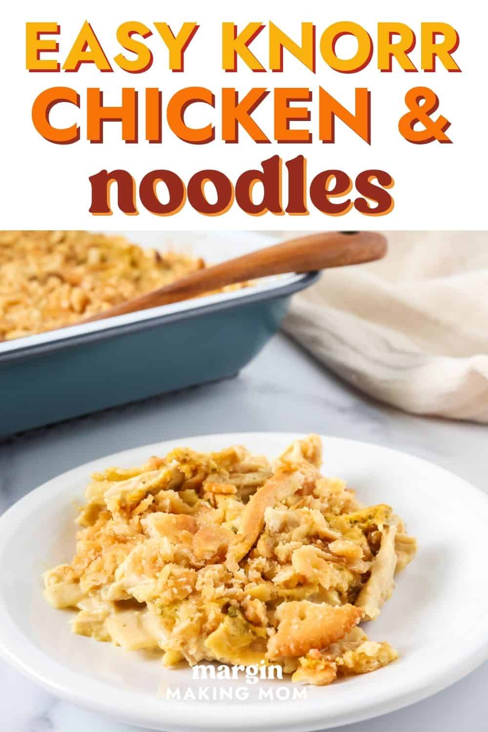 A serving of Knorr chicken and noodles casserole on a white plate, with the baking dish of remaining casserole in the background.