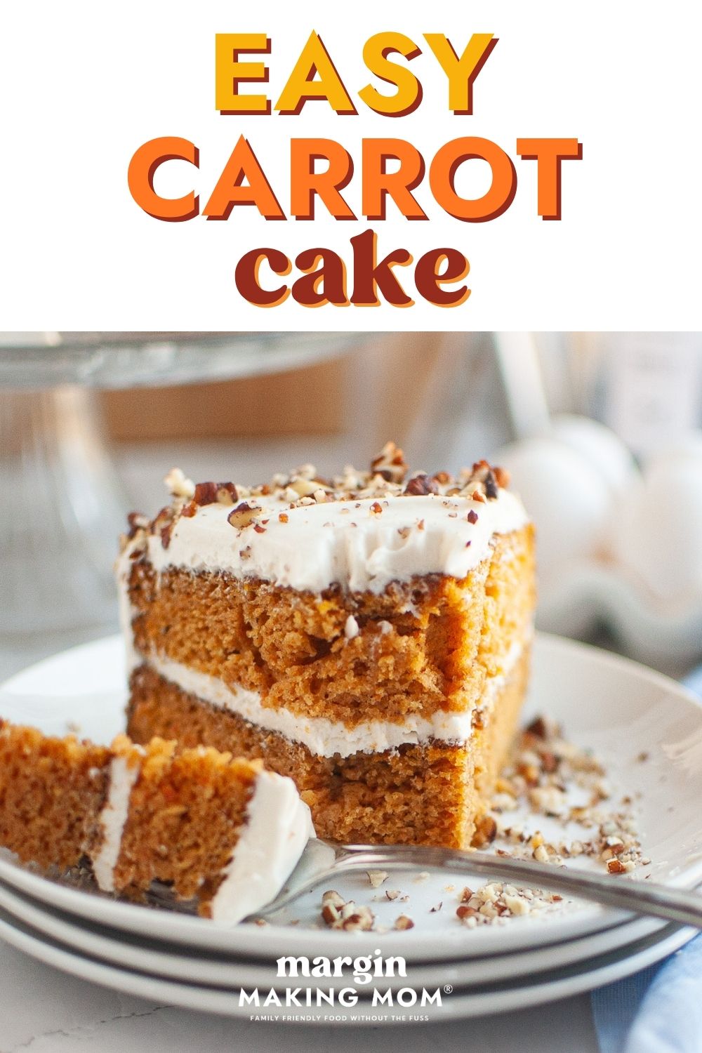 Slice of easy carrot cake made with canned carrots. A fork has taken a bite out of the cake and is resting on the plate next to the slice.