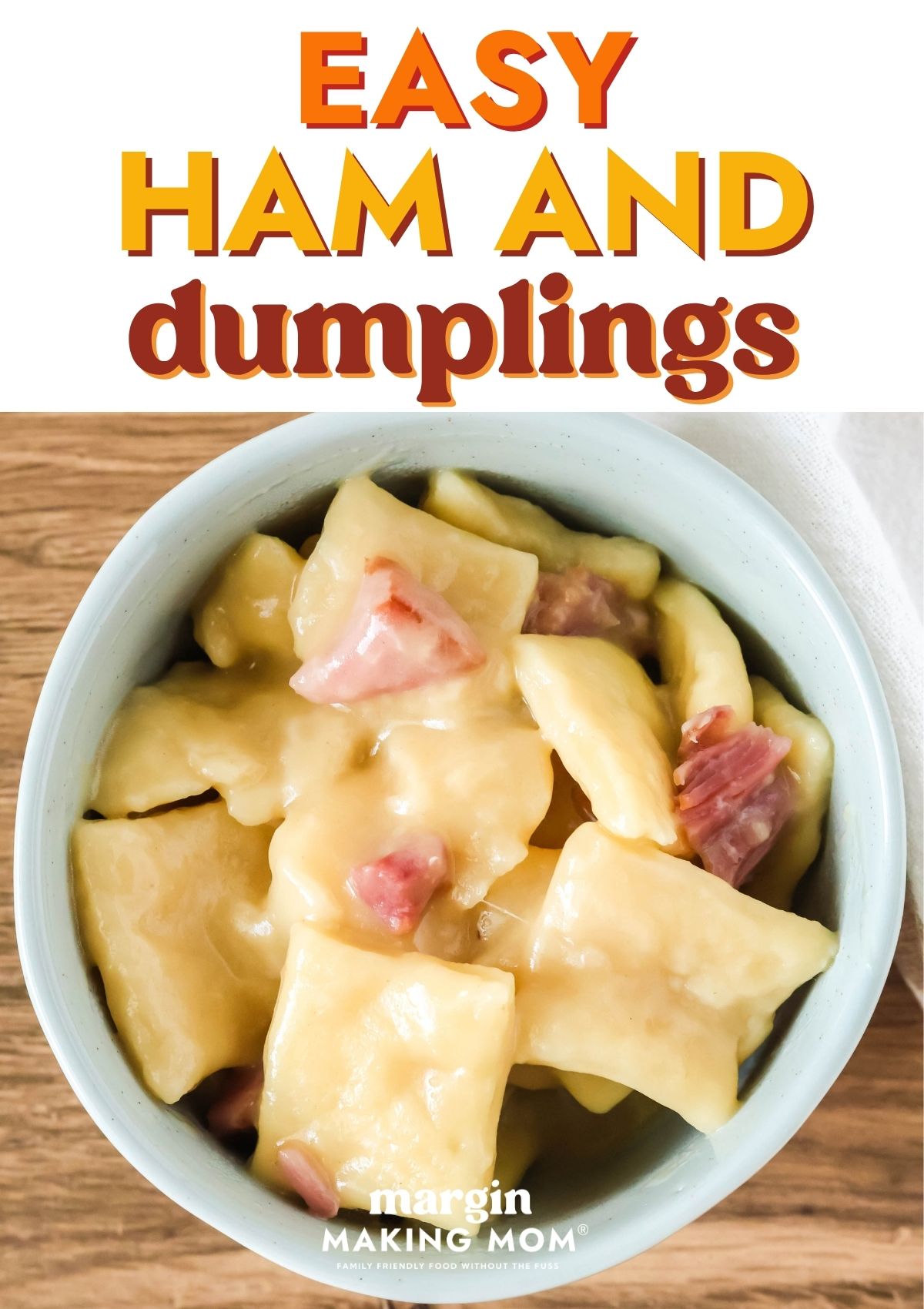 Overhead view of ham and dumplings served in a light blue bowl.