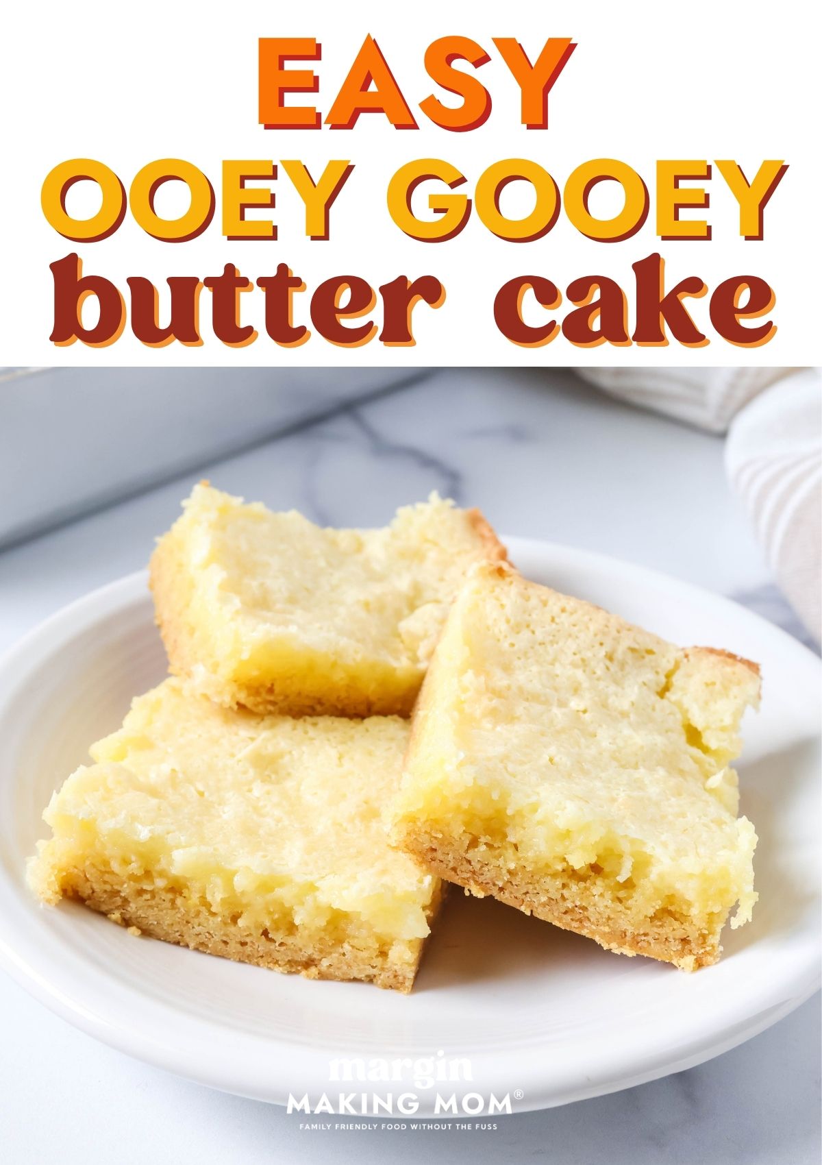 Easy ooey gooey butter cake squares on a white plate.