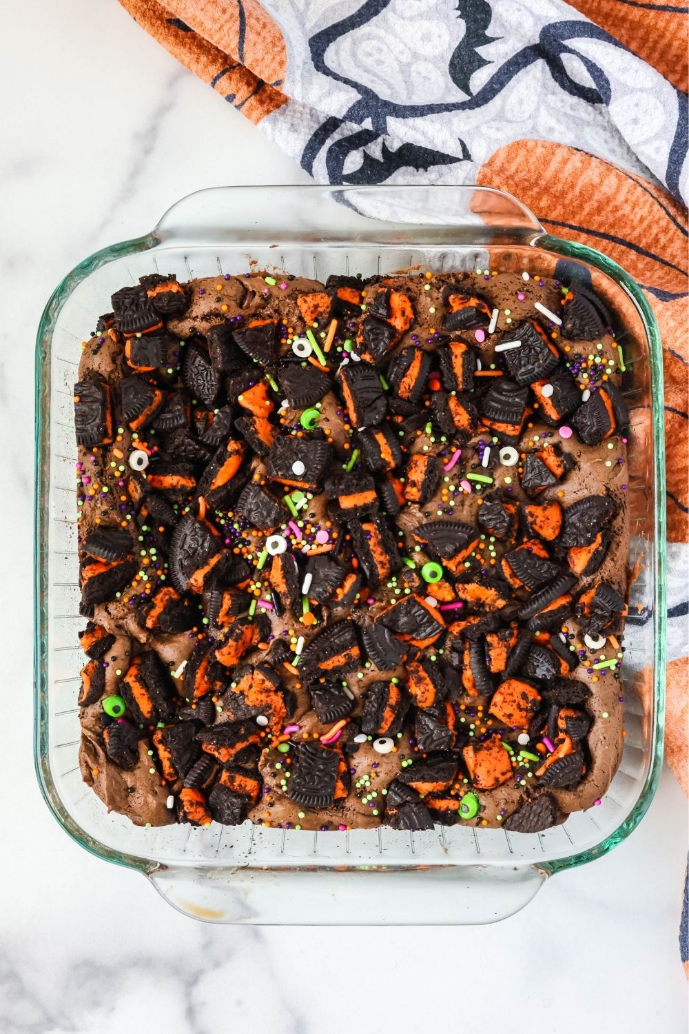 Overhead view of a glass baking dish of a chocolate Oreo Halloween dessert.