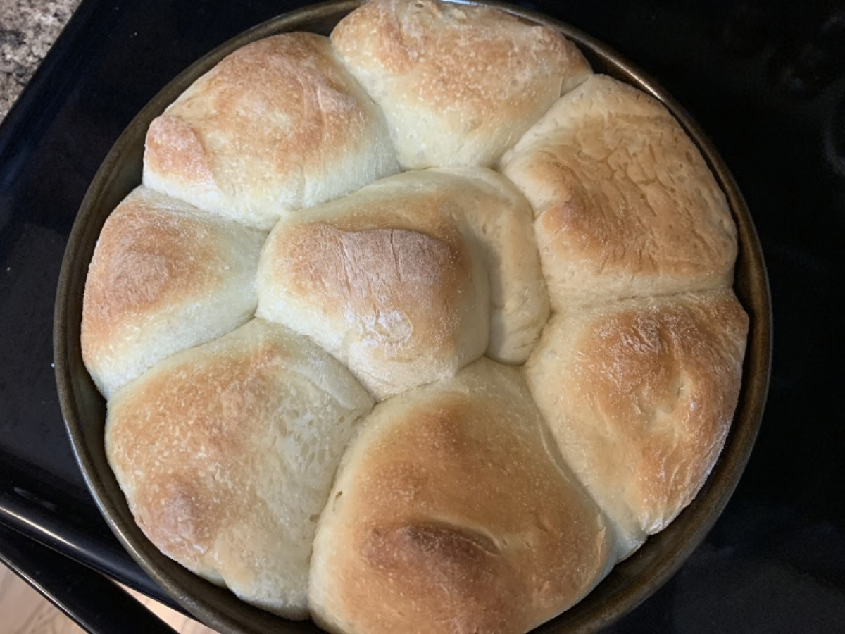 Pan of freshly baked dinner rolls that were made from frozen yeast roll dough.